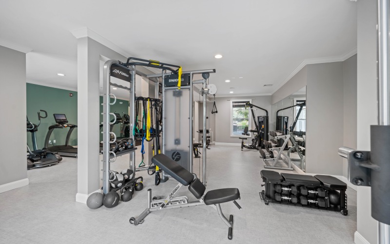 Fitness center with lots of equipment and natural lighting