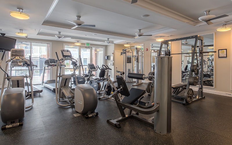 Fitness center with lots of equipment and natural lighting